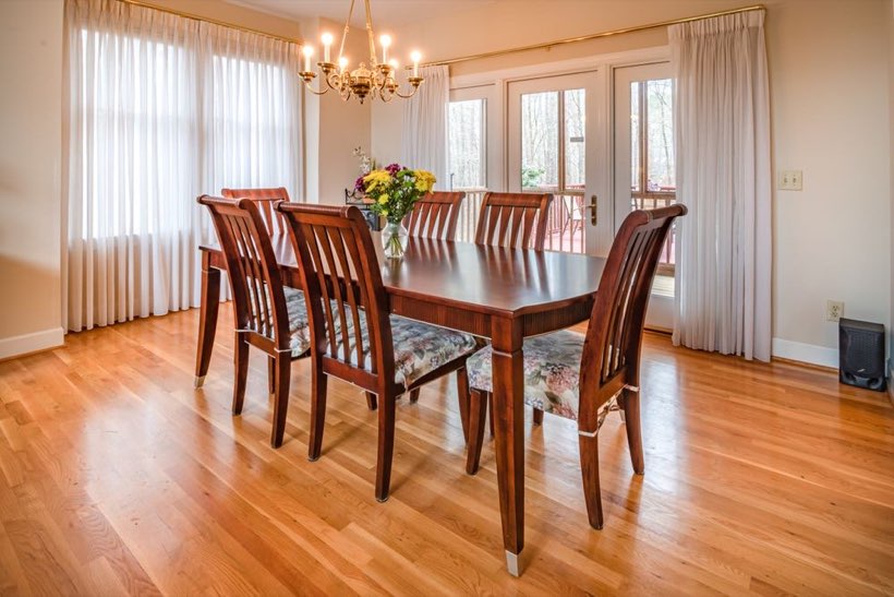 Refinished oak flooring in a Garneau dining room with french doors.
